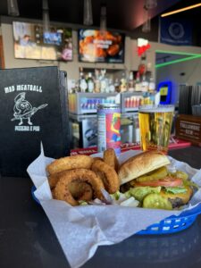 burger and onion rings in. a basket